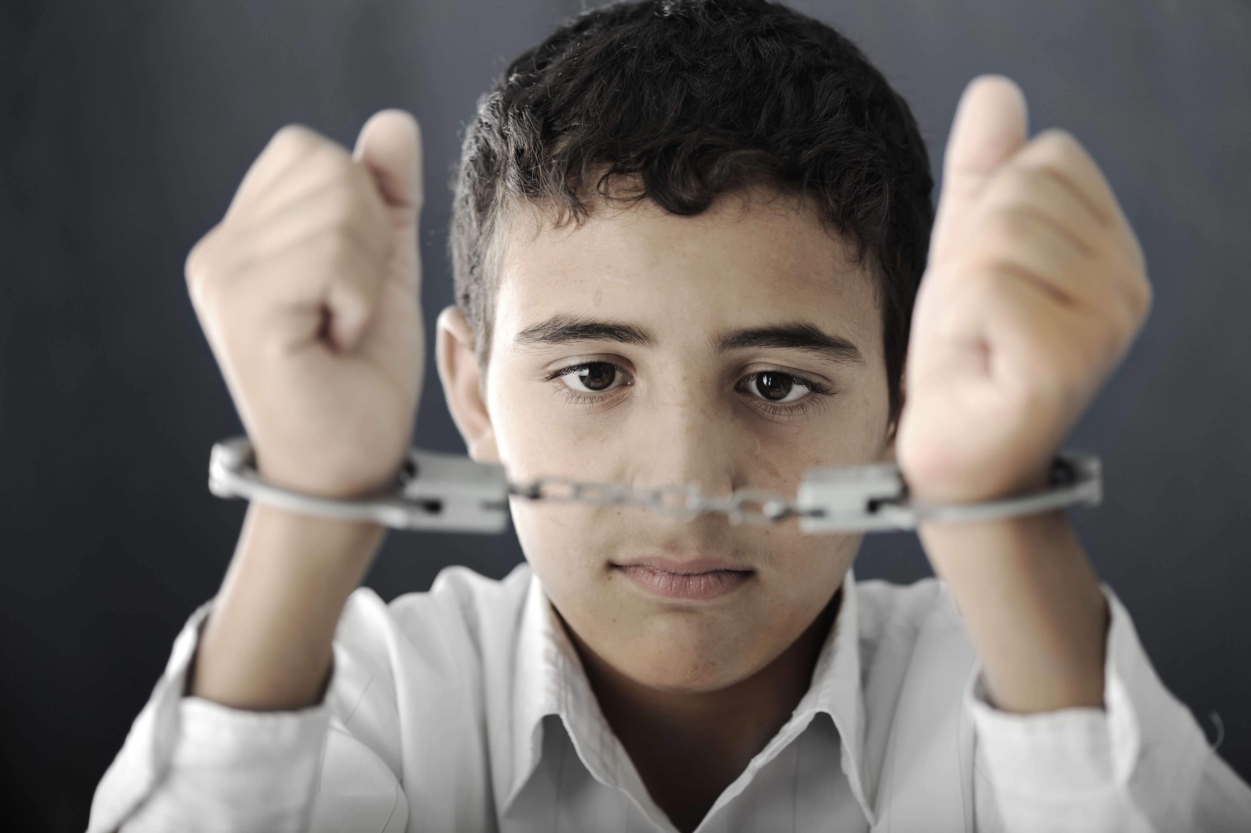 Child in handcuffs - juvenile criminal charges